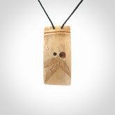 A hand carved bamboo with snail pendant carved from a piece of deer antler. This is a work of art carved by Fumio Noguchi who is renowned for his skill in bone carving. This is a great piece representing this very cool plant and animal.